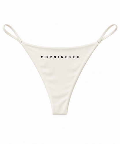 An off-white thong-style bikini bottom with thin side straps and the brand name 'MORNINGSEX' printed in black across the front, shown on a plain white background.