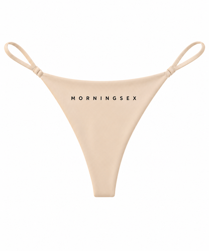 Beige string bikini bottom with thin shoulder straps and the brand name 'MORNINGSEX' printed in black across the front, shown on a plain white background.