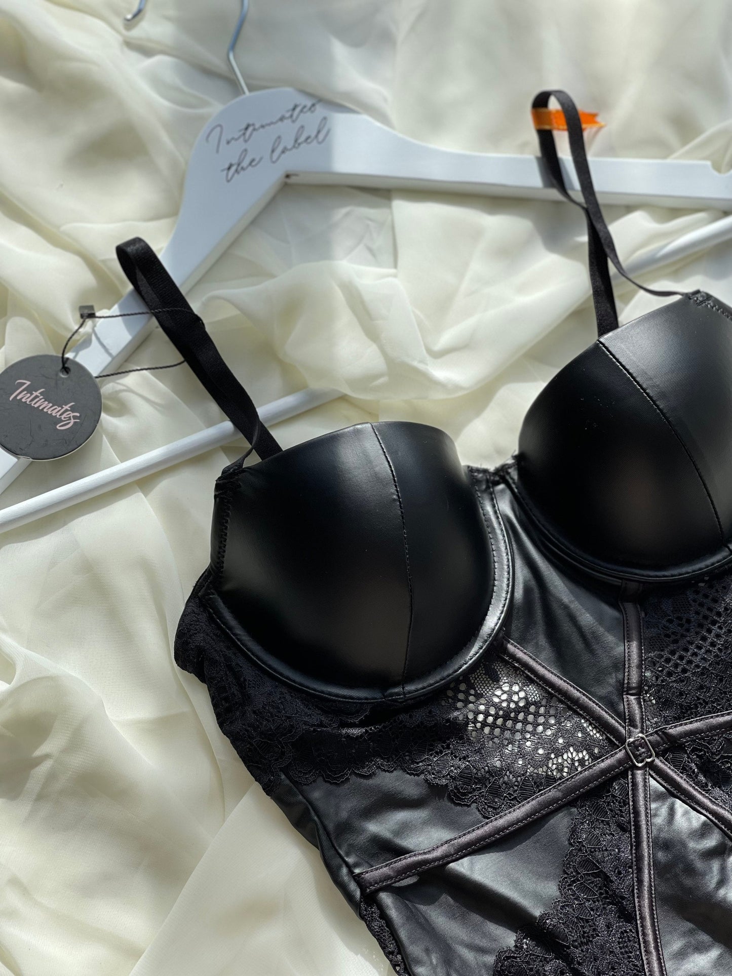 Black Undone Noir Sculpt bodysuit, form-fitting lingerie with sleek design and sexy silhouette, shown on a model.