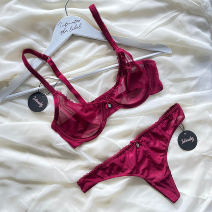 Red lingerie set on a white surface 