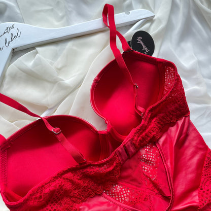 Close-up of the red Noir Sculpt Bodysuit by Undone, showcasing its fitted design and textured fabric details.