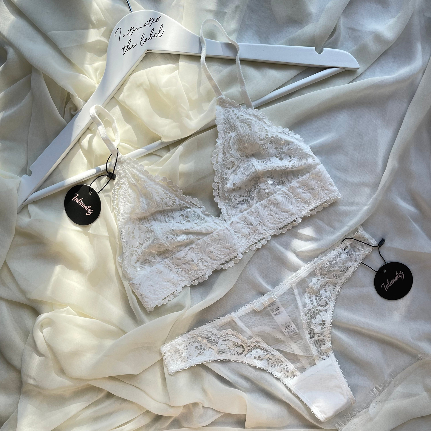 Undone white lace wireless lingerie set with delicate floral patterns, featuring a matching bra and panties for bridal or special occasions.