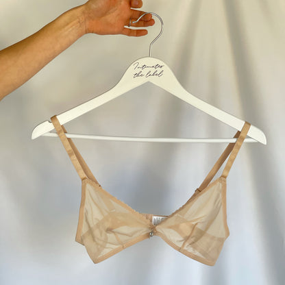 Nude bralette on a hanger 