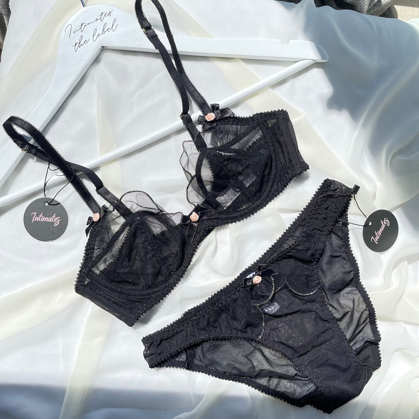 Black sheer luxury minimal lingerie set by Undone, featuring delicate straps and smooth, transparent fabric.