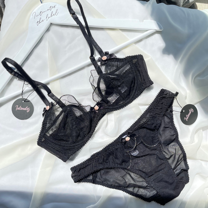Black sheer luxury minimal lingerie set by Undone, featuring delicate straps and smooth, transparent fabric.
