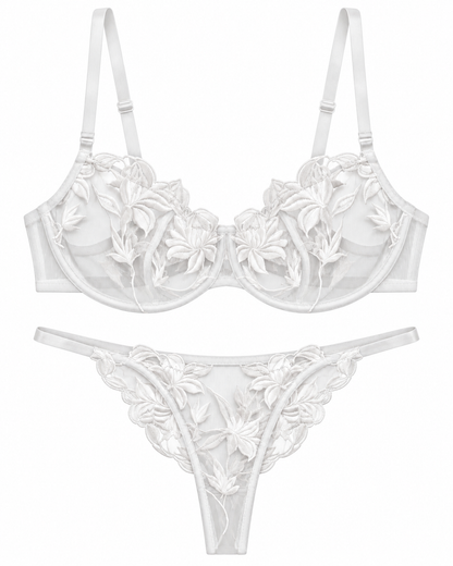 White sheer mesh lingerie set with 3D floral lace applique, featuring a structured underwire bra and a matching thong on a plain white background.
